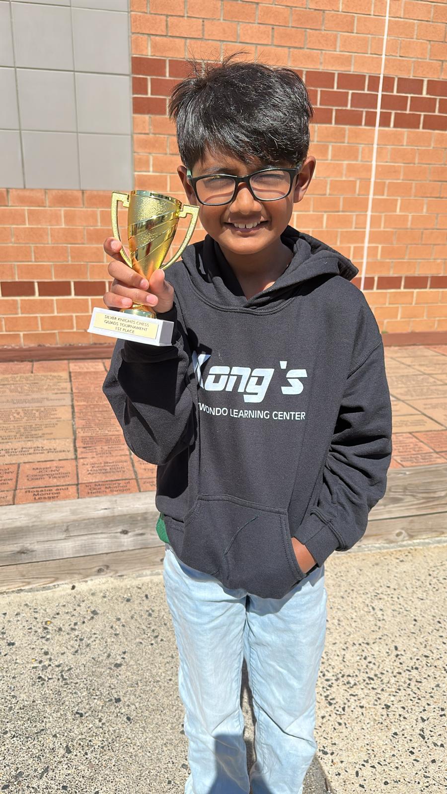 Student holding his tournament trophy
